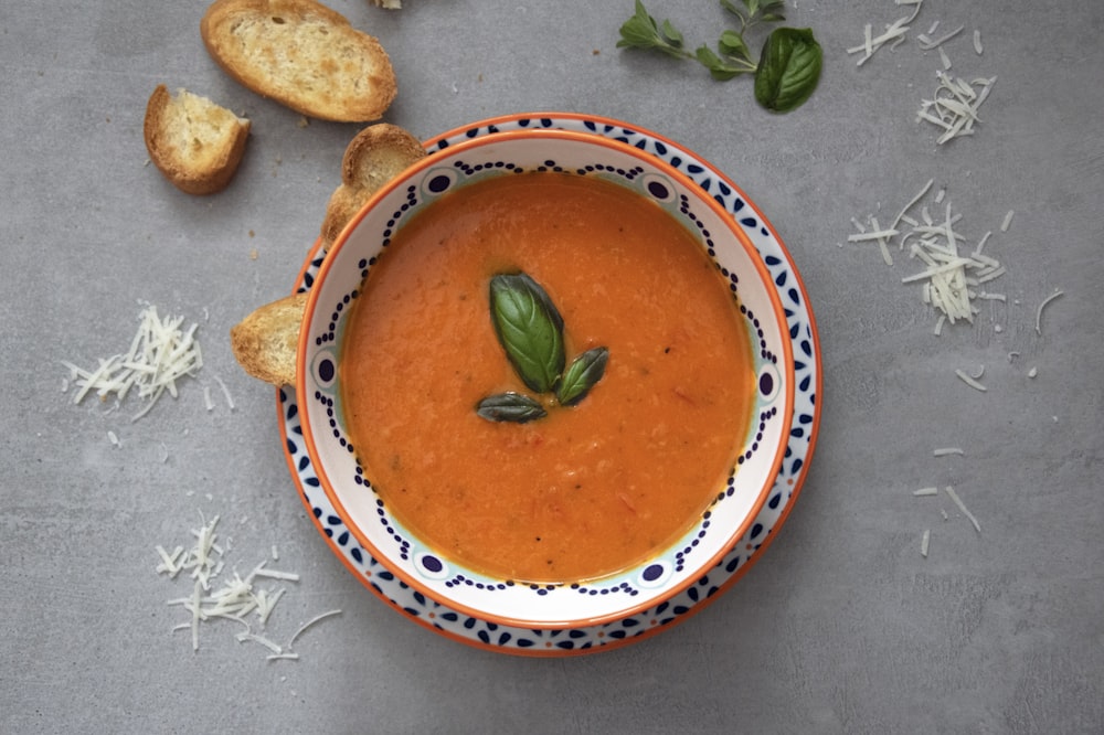 brown soup on white and blue ceramic bowl