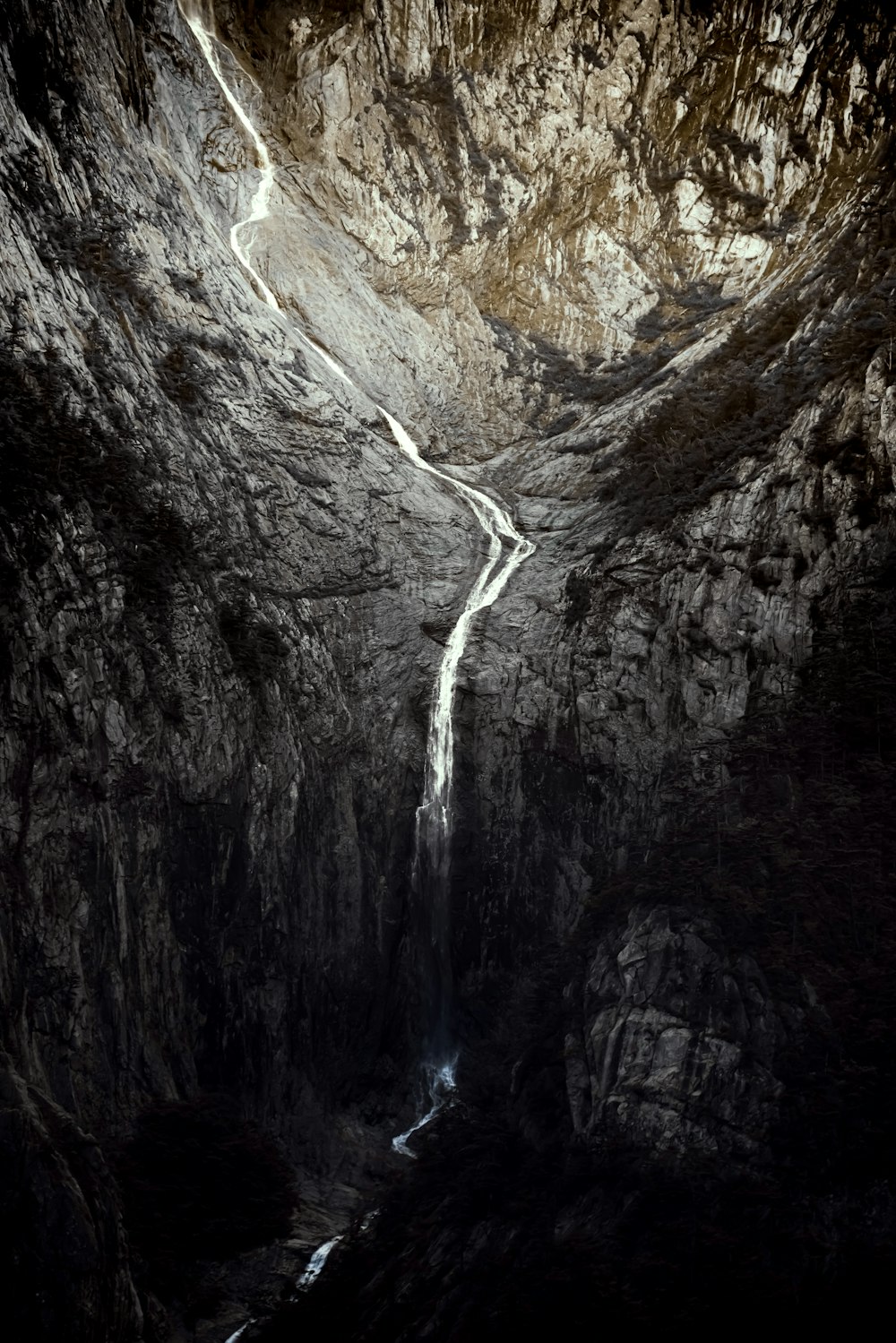 water falls in the middle of rocky mountains