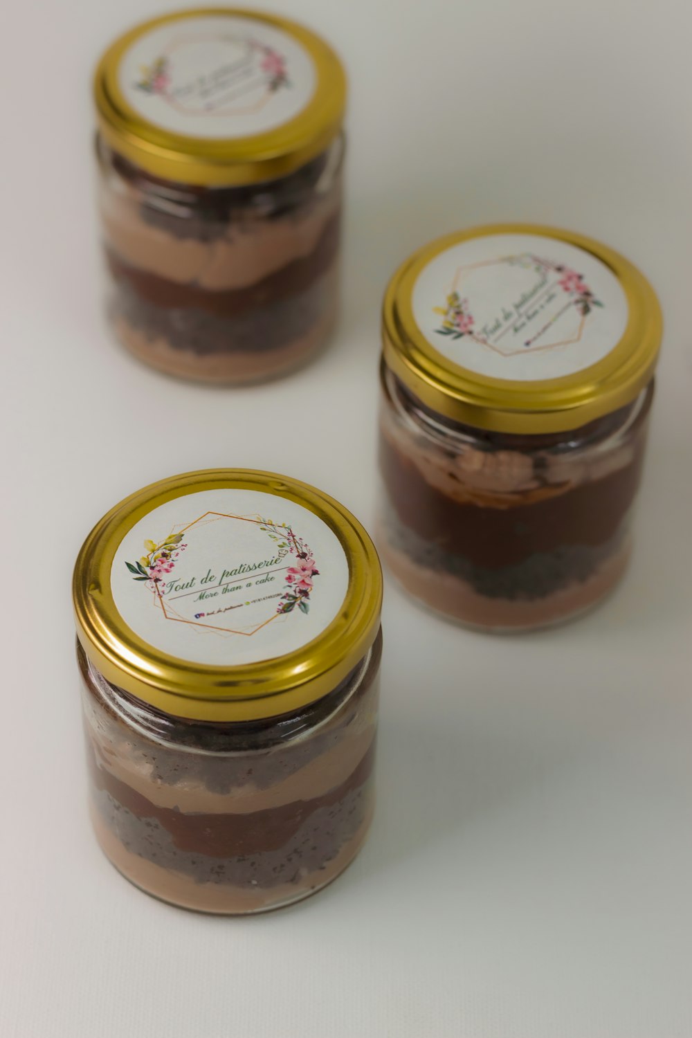 two brown and white labeled jars