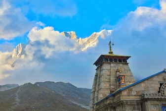 gray concrete tower on top of mountain during daytime