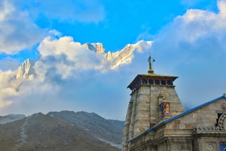 gray concrete tower on top of mountain during daytime