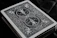 Close-up of detailed custom TCG cards with geometric and spicy art style.