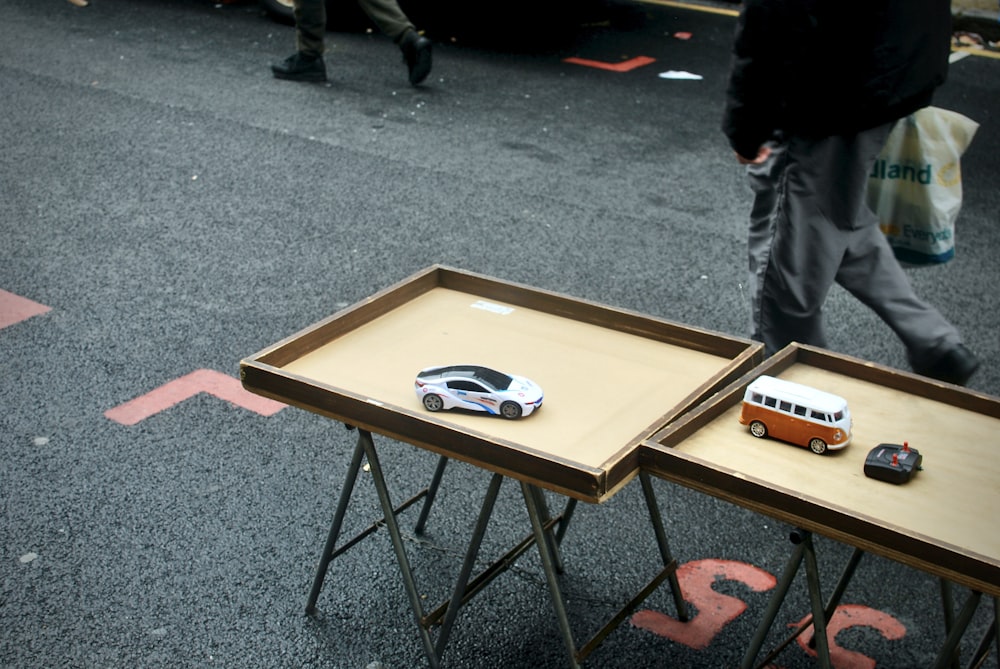 brown wooden table on gray carpet