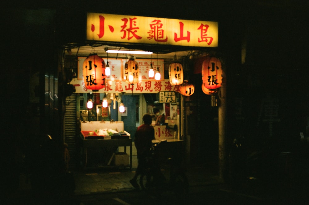 people sitting on chair near store during night time