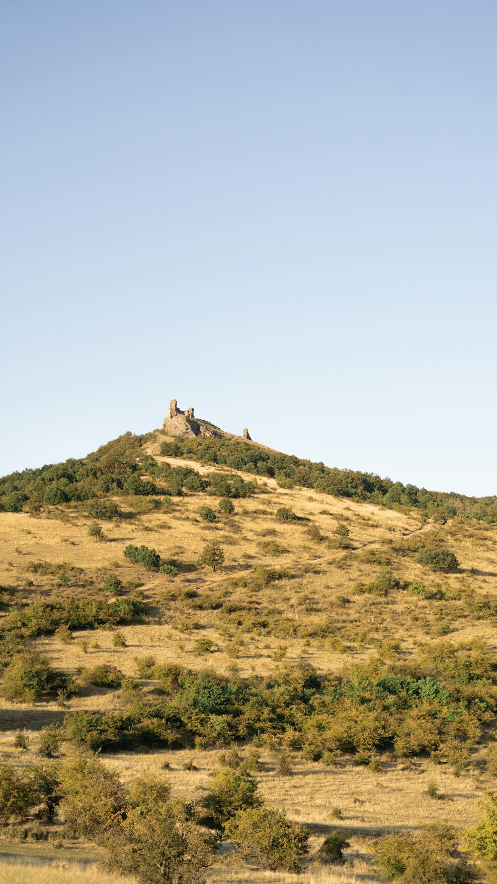 brown mountain under blue sky during daytime