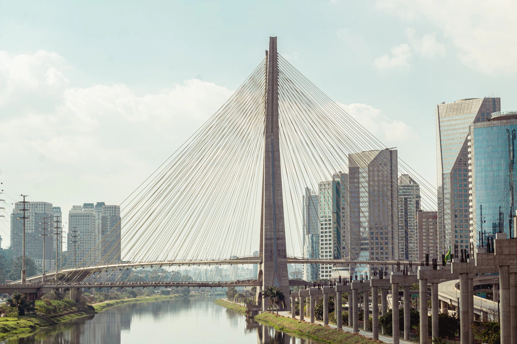 Gray concrete bridge over the Pinheiros River in São Paulo, Brazil — knowing the city layout helps you reach safe locations fast after a scam incident. Photo by Bruno Thethe
