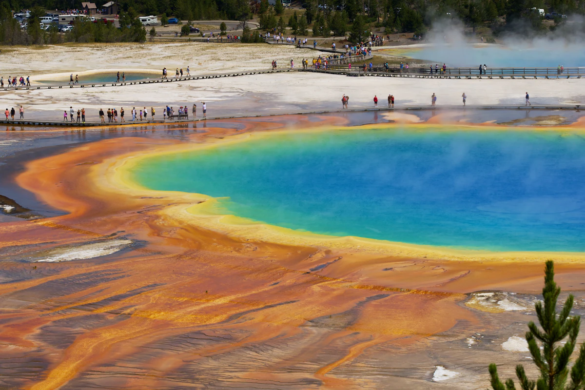 A geothermal basin and open plain in Yellowstone National Park under a wide sky