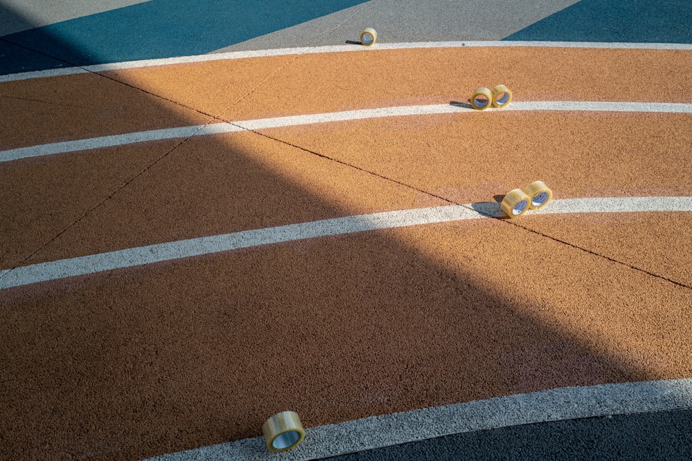 white and yellow ball on brown and white track field