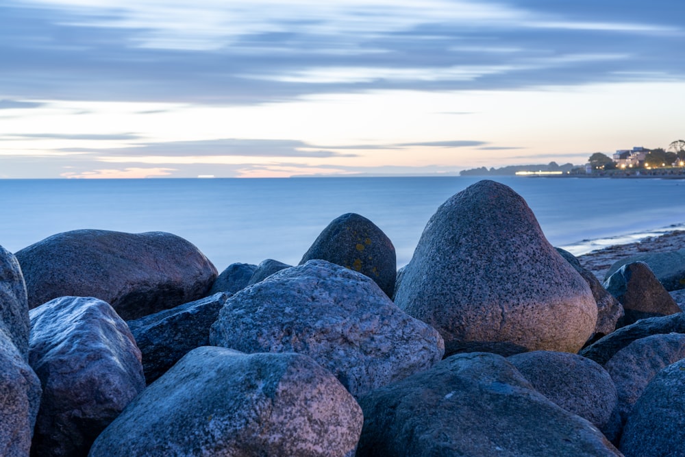 gray and brown rocks near body of water during daytime