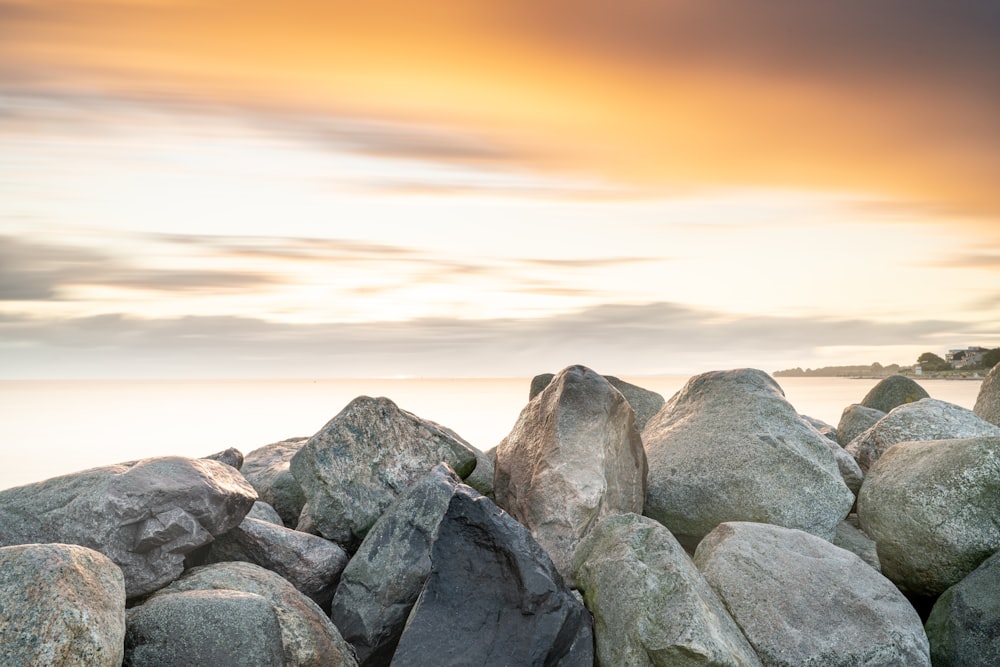 a bunch of rocks sitting on top of a beach