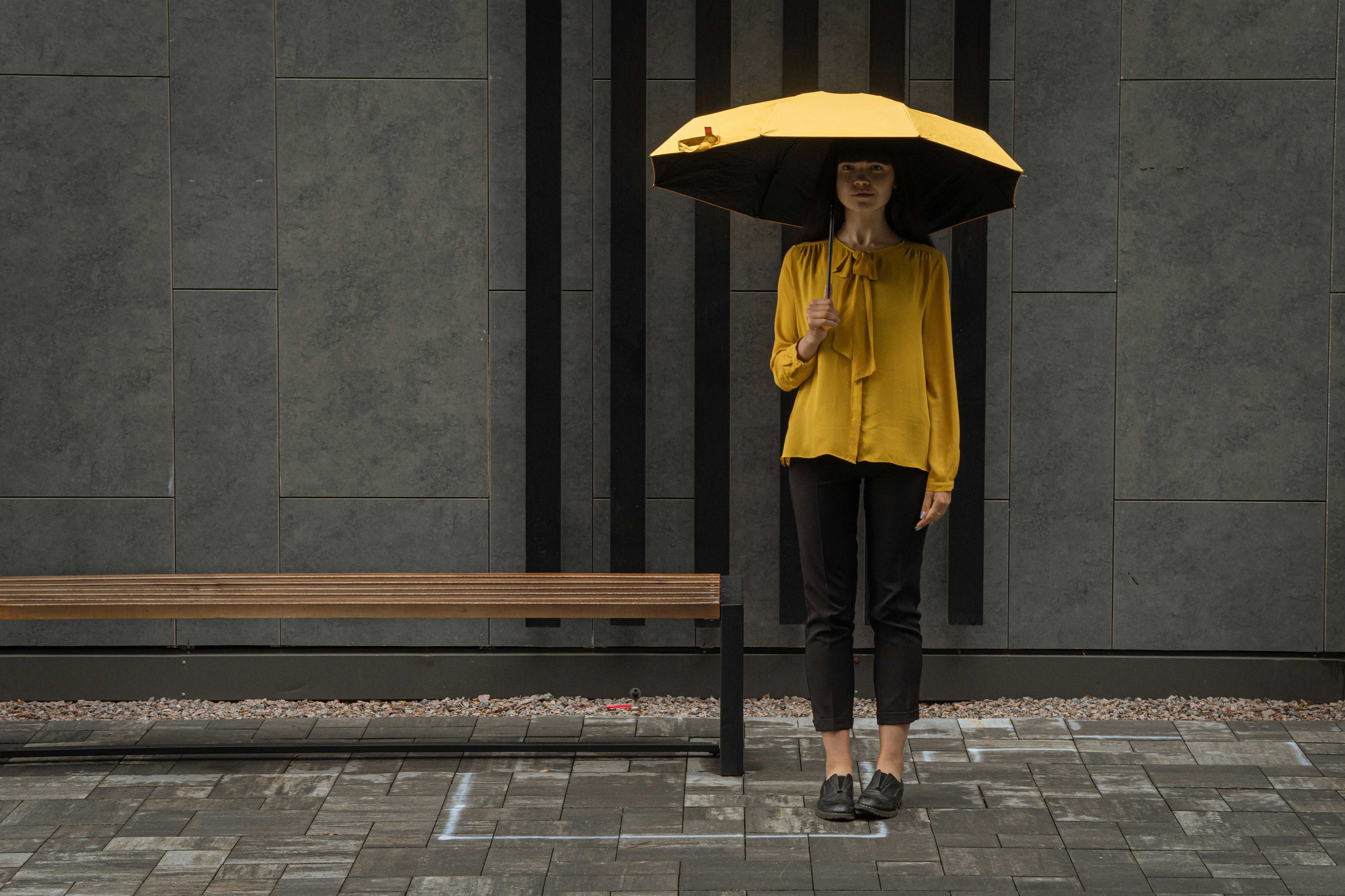 우산 추천 BEST 10 (튼튼함 기준) - woman in yellow jacket and black pants holding umbrella