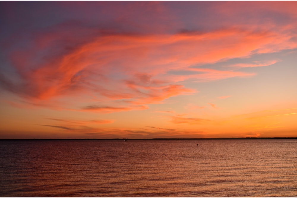 body of water during sunset