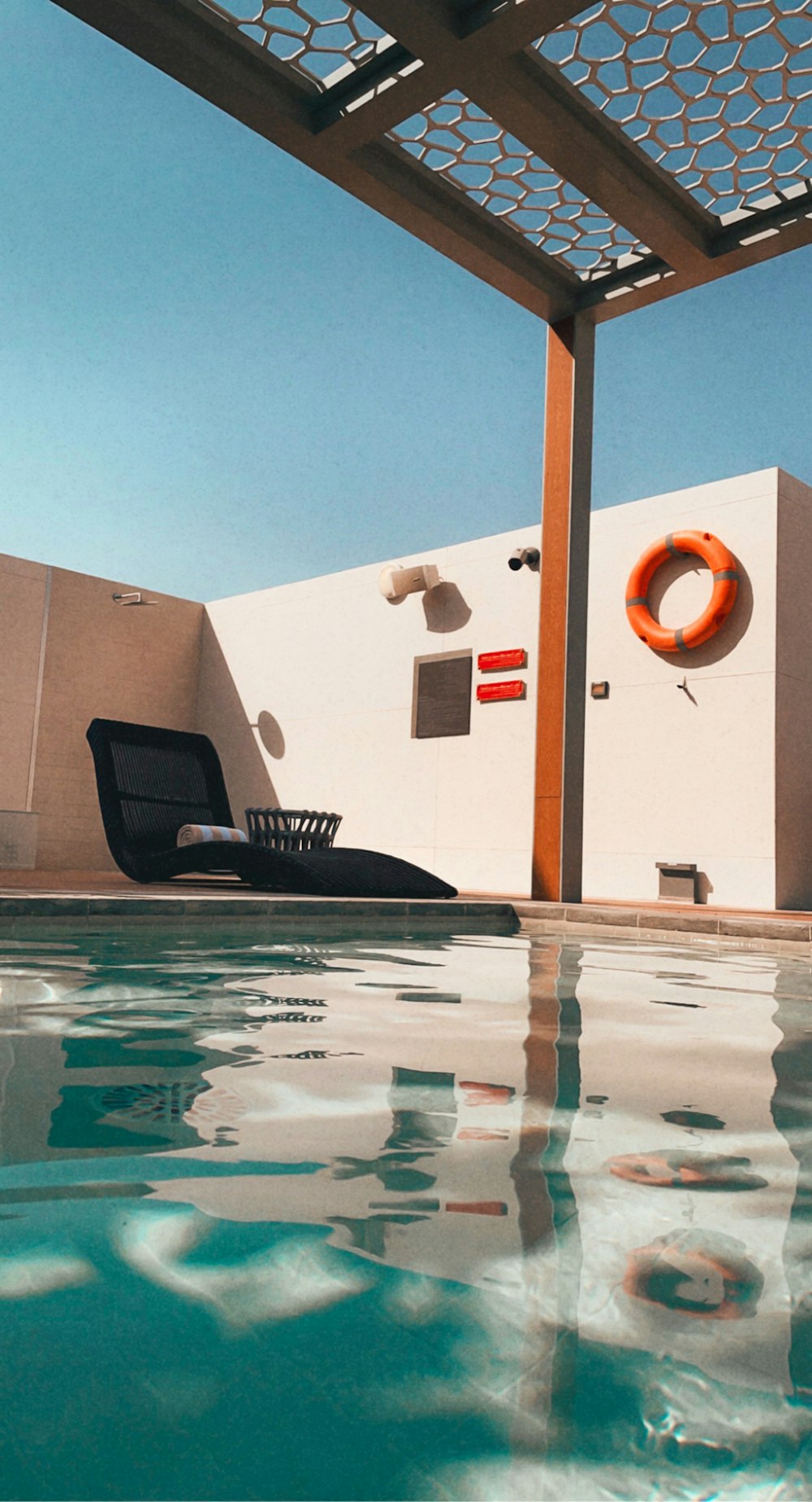 black and white inflatable boat on swimming pool during daytime