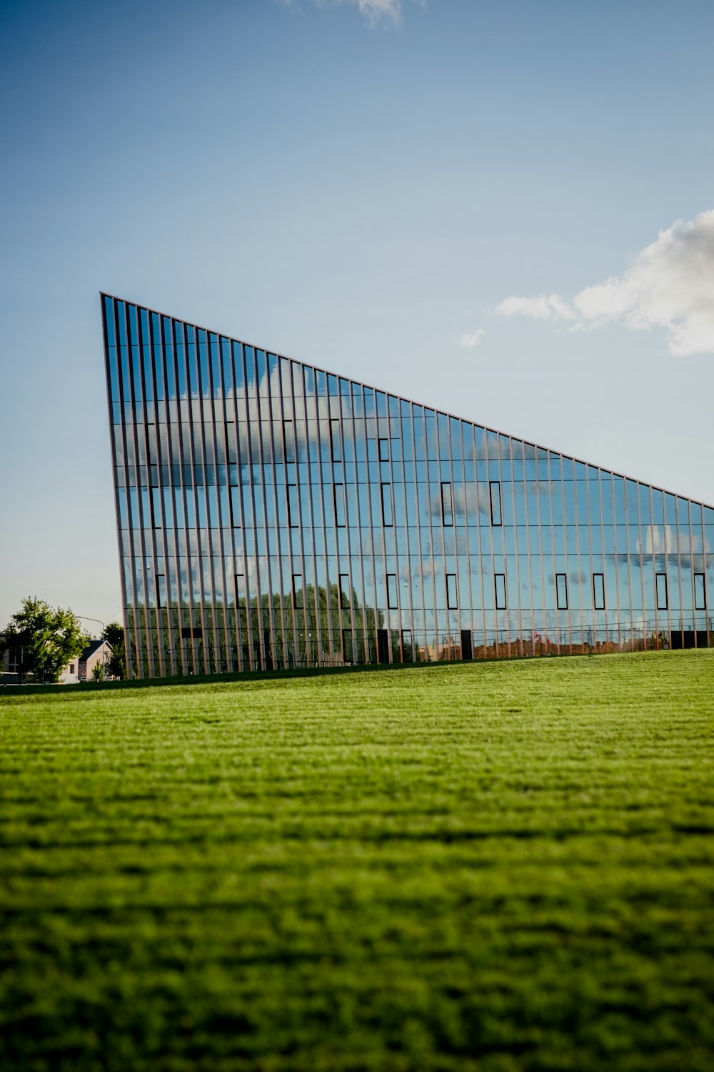glass building on green grass field during daytime