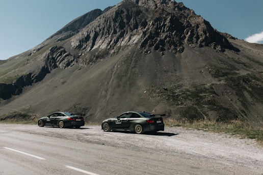 black coupe on gray asphalt road during daytime