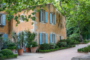 brown concrete building near green trees during daytime