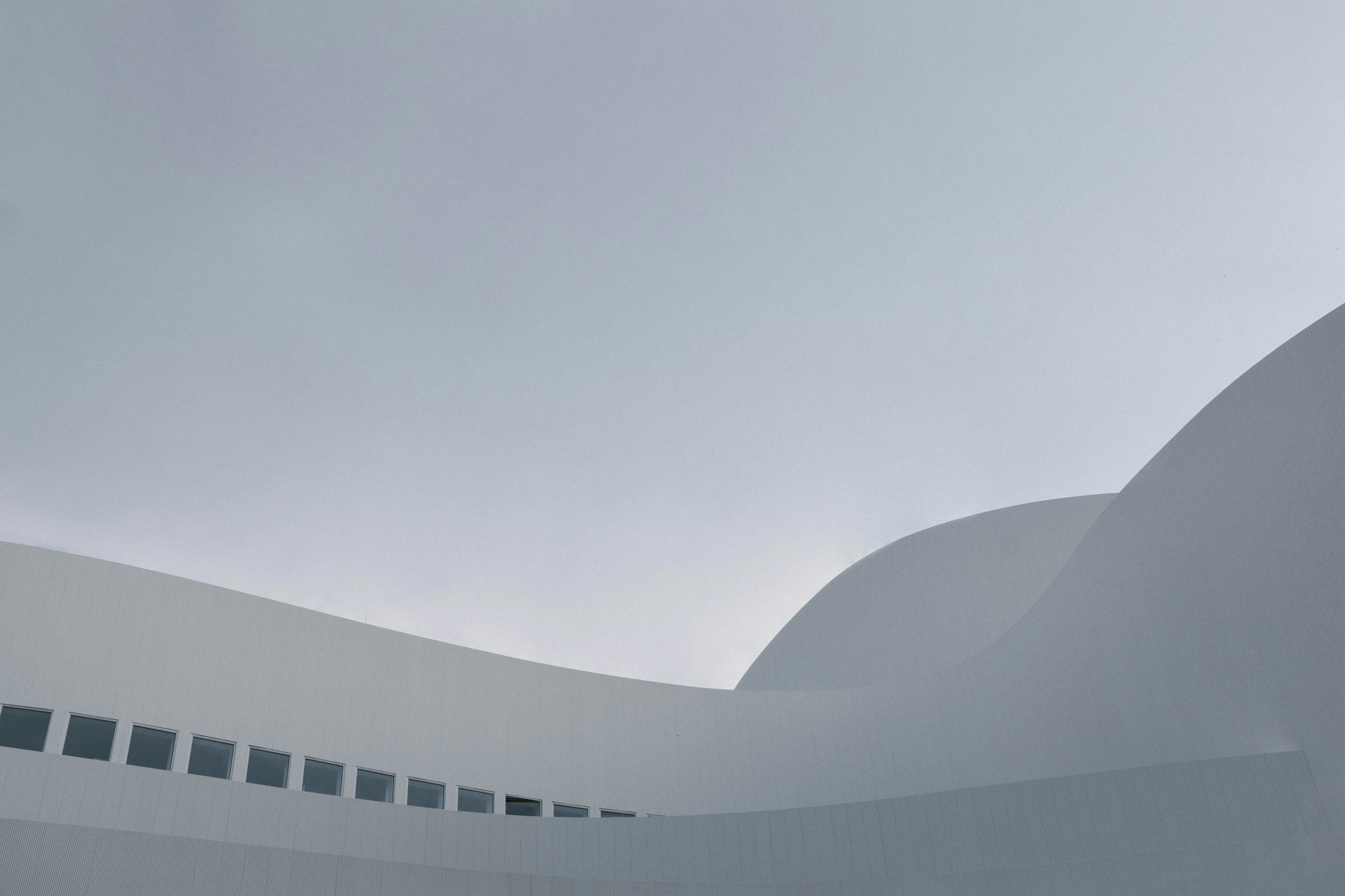 white concrete building under white sky during daytime