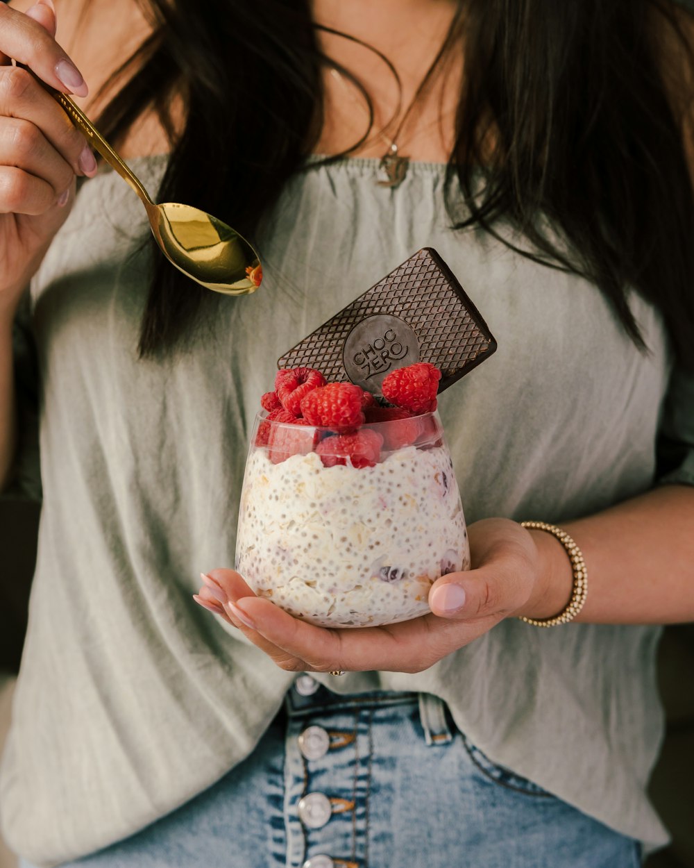 woman holding white and pink floral pouch