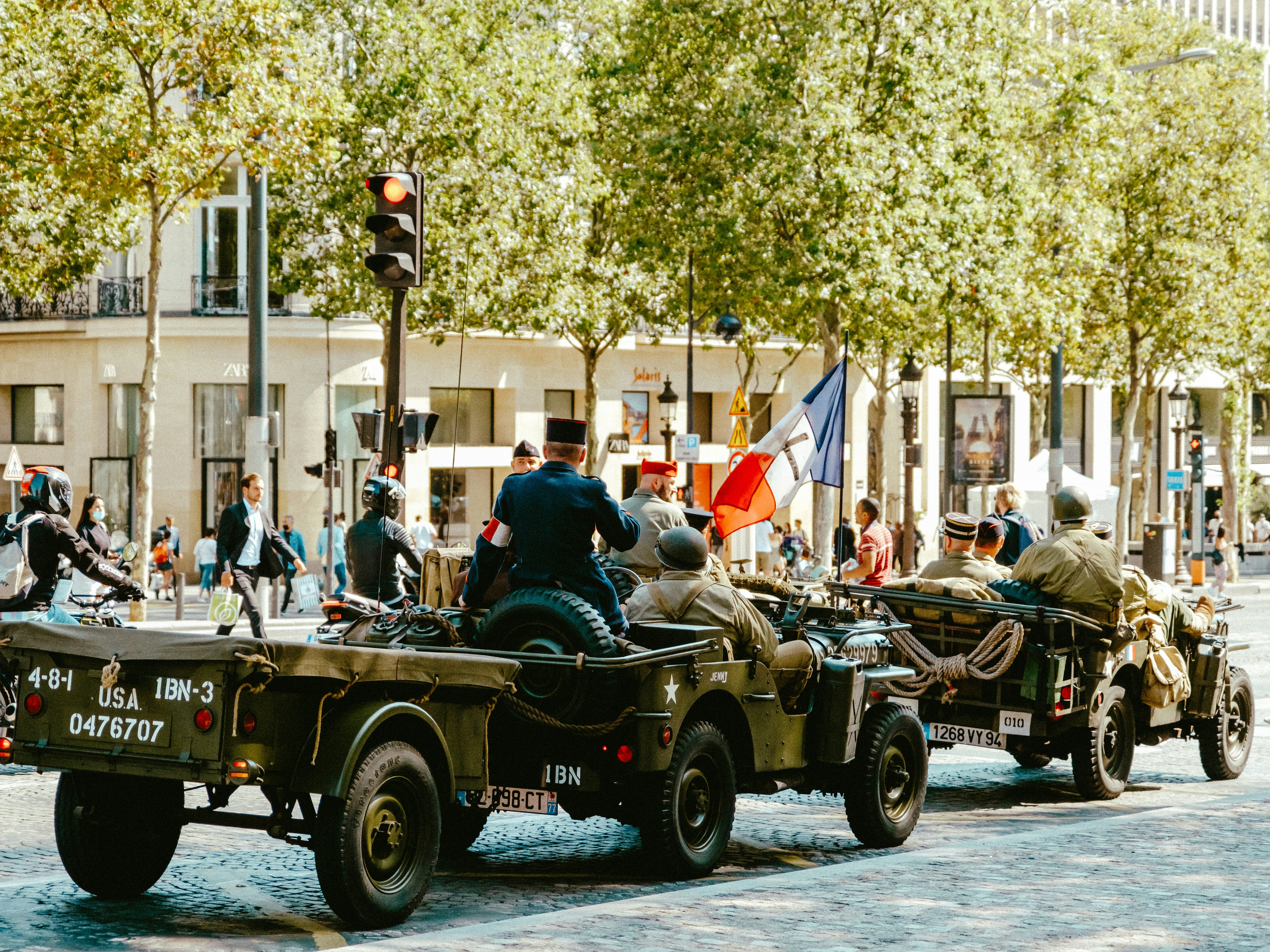 people riding on green and brown vintage car during daytime