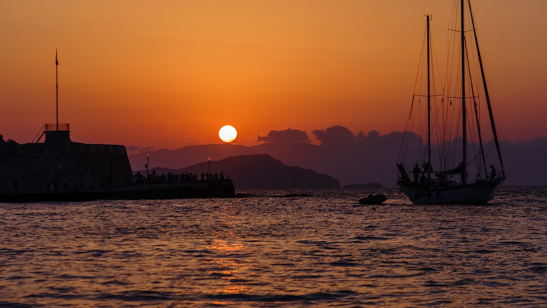 silhouette of boat on sea during sunset