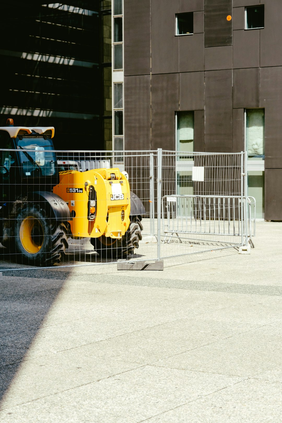 yellow and black heavy equipment near building