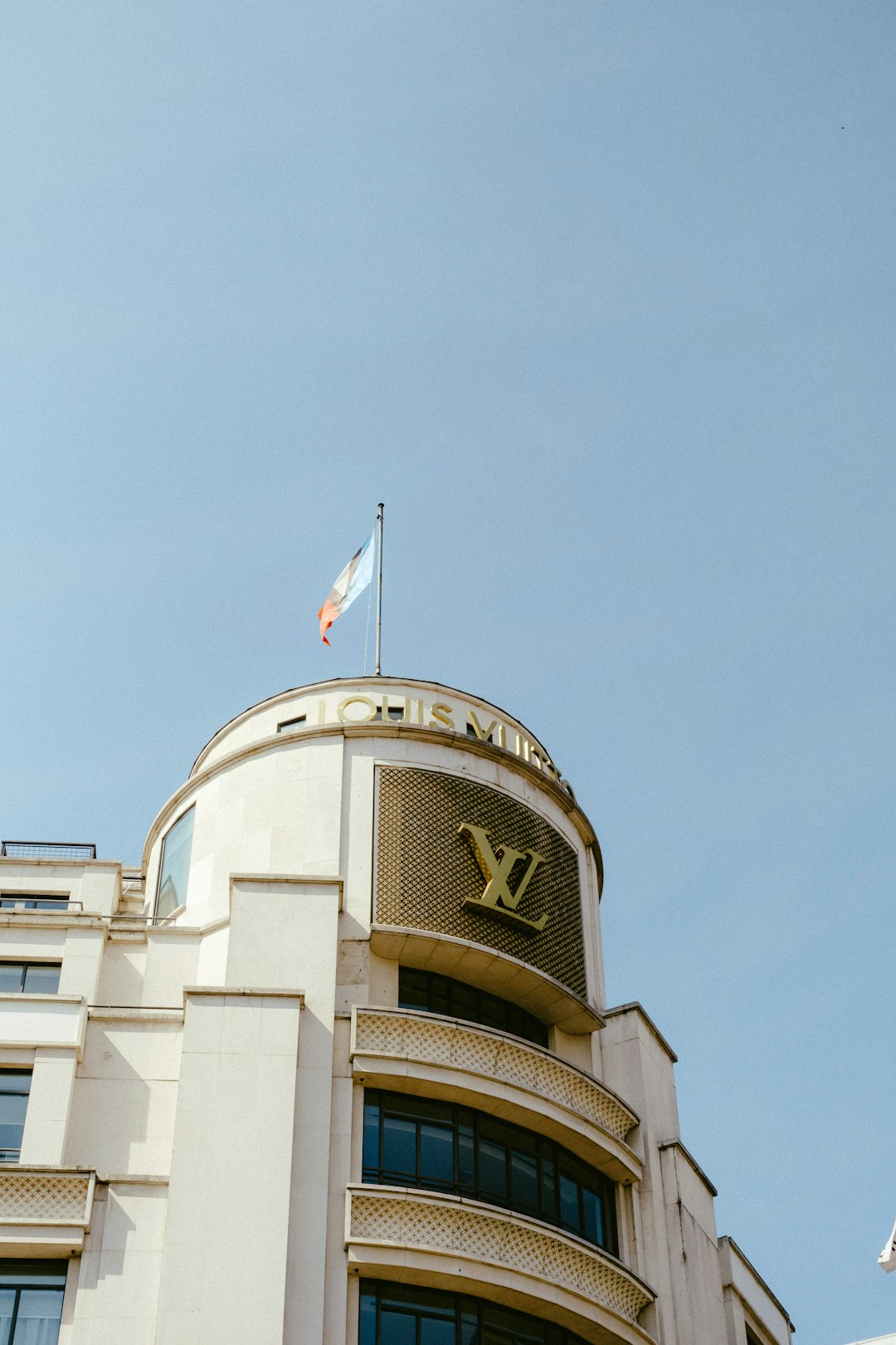 white and brown concrete building with flag of us a on top