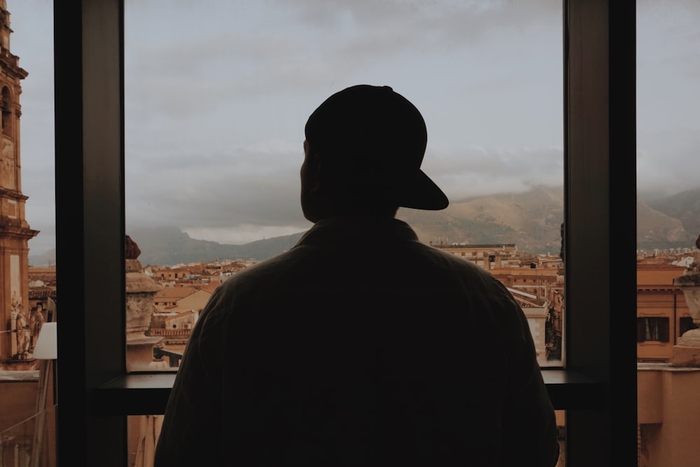 silhouette of man wearing black hat