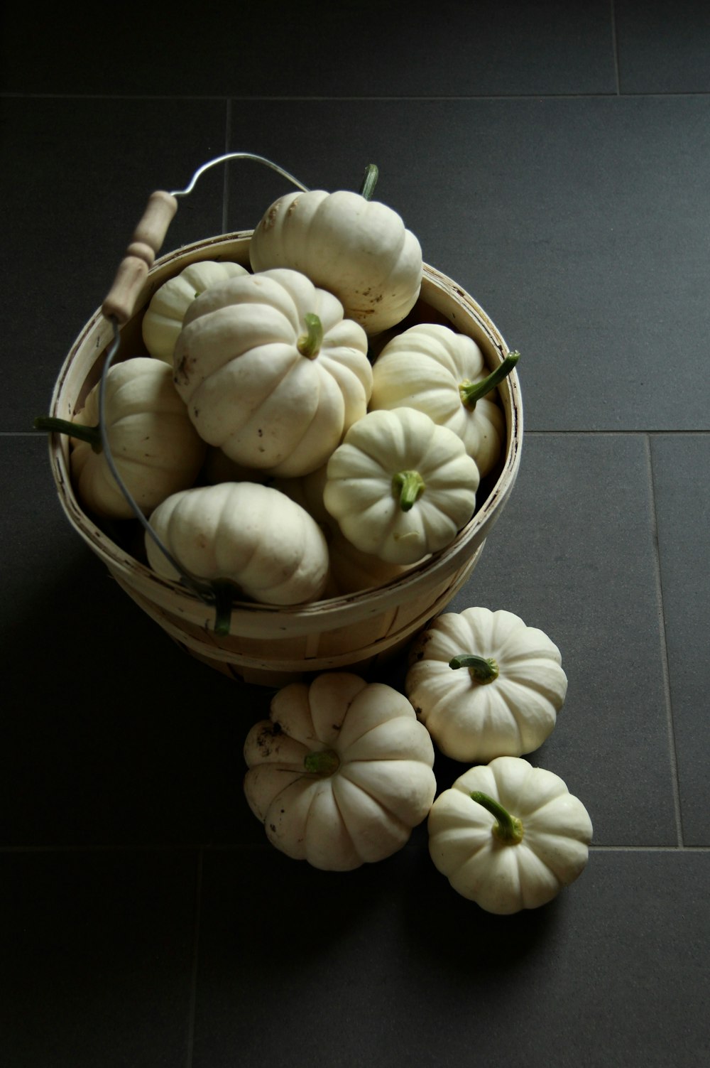 white garlic on brown wooden bucket