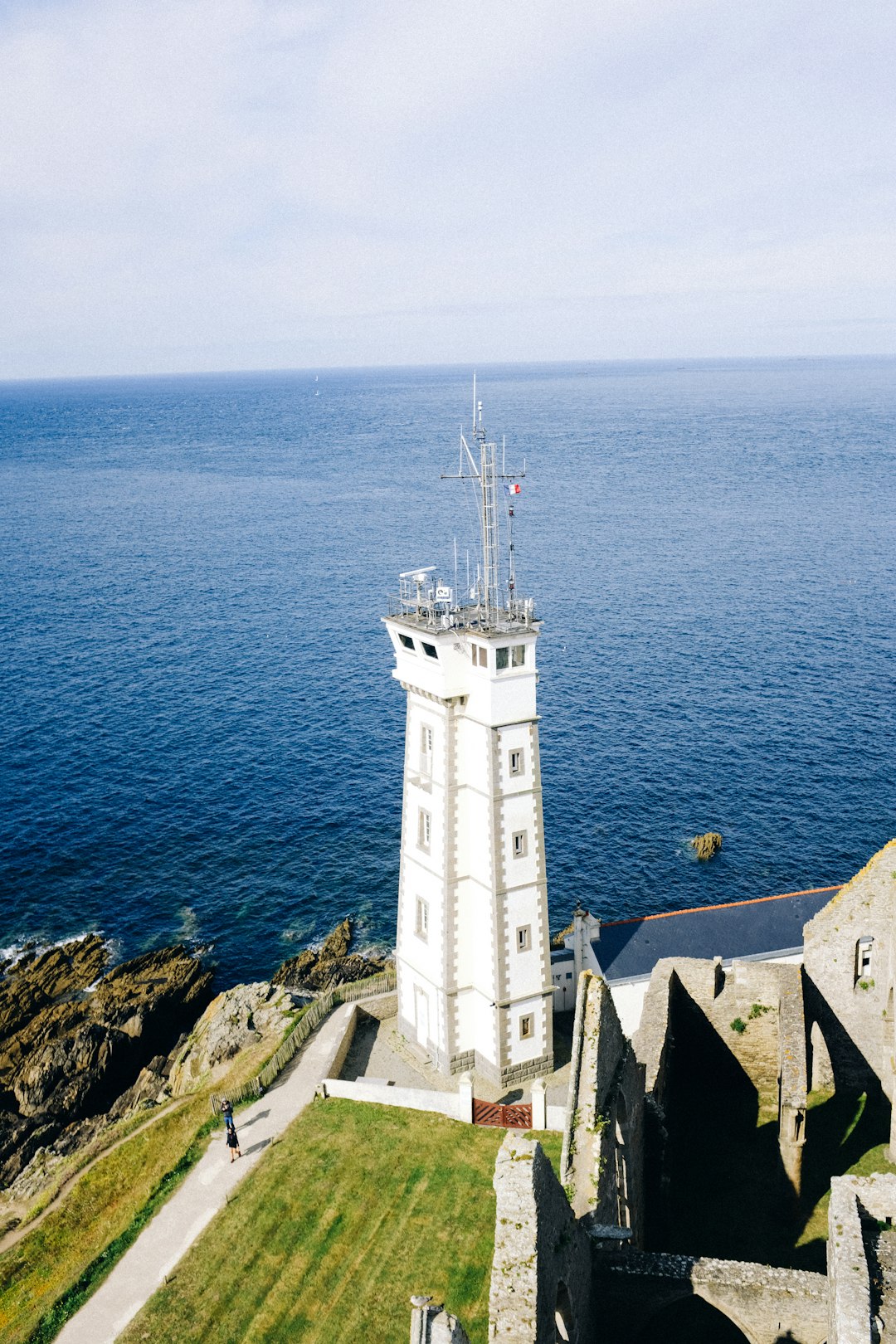 white concrete lighthouse near body of water during daytime