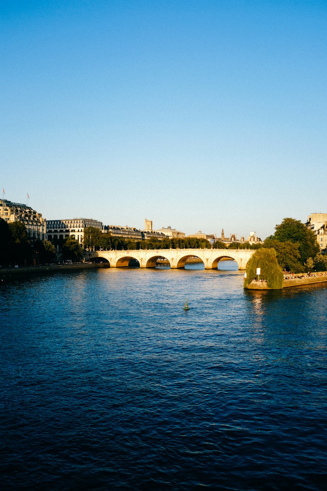 brown concrete bridge over blue sea during daytime