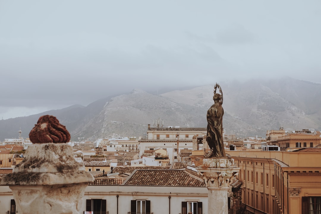 man statue on top of building