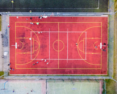 Aerial view of a multi-sport court with crisp lines and modern fencing.