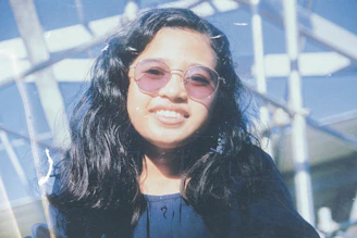 woman in black jacket wearing brown framed eyeglasses