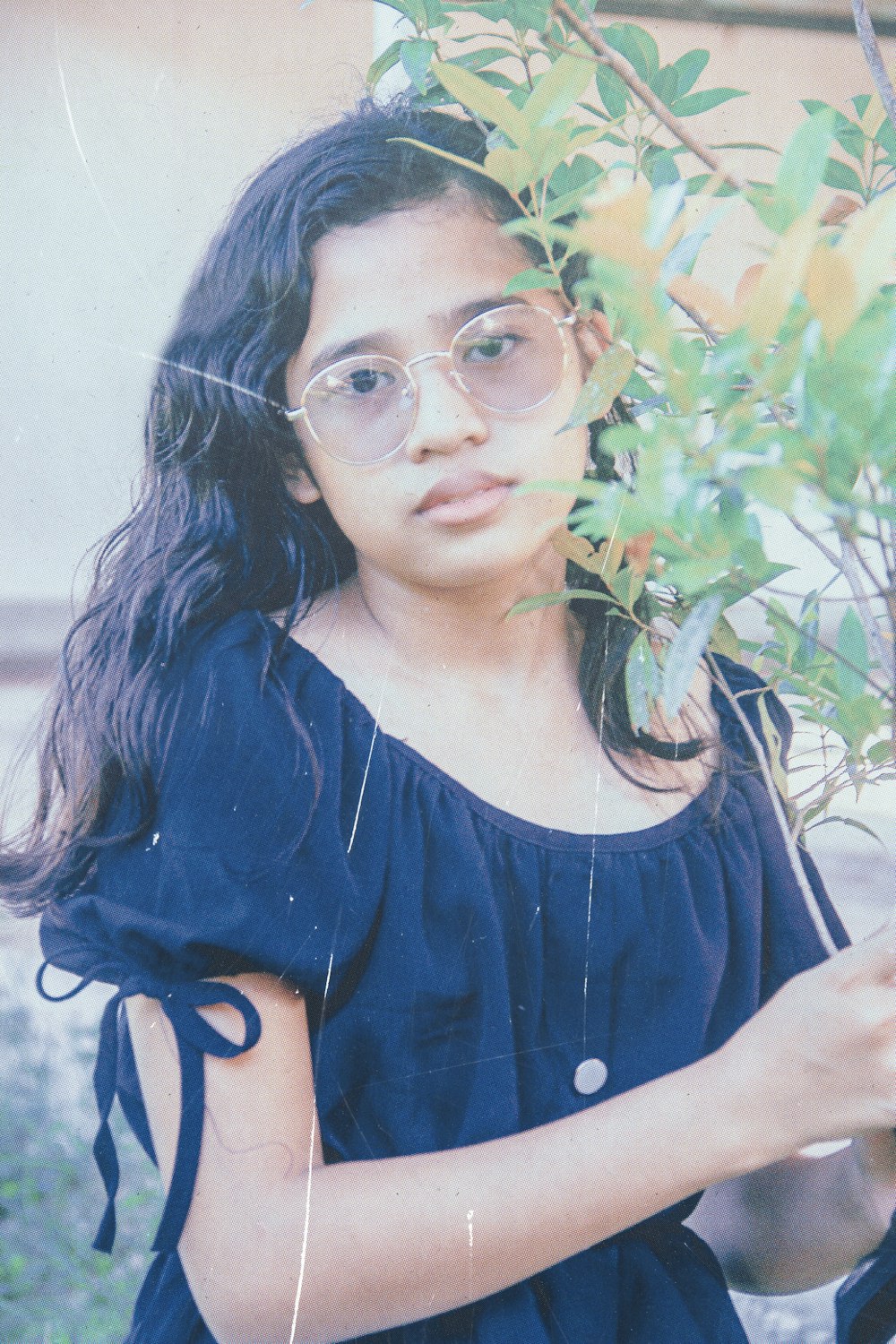 woman in blue scoop neck shirt wearing eyeglasses