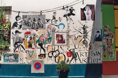 A vibrant wall showcasing mixed-media art pieces blending urban and hippie styles.