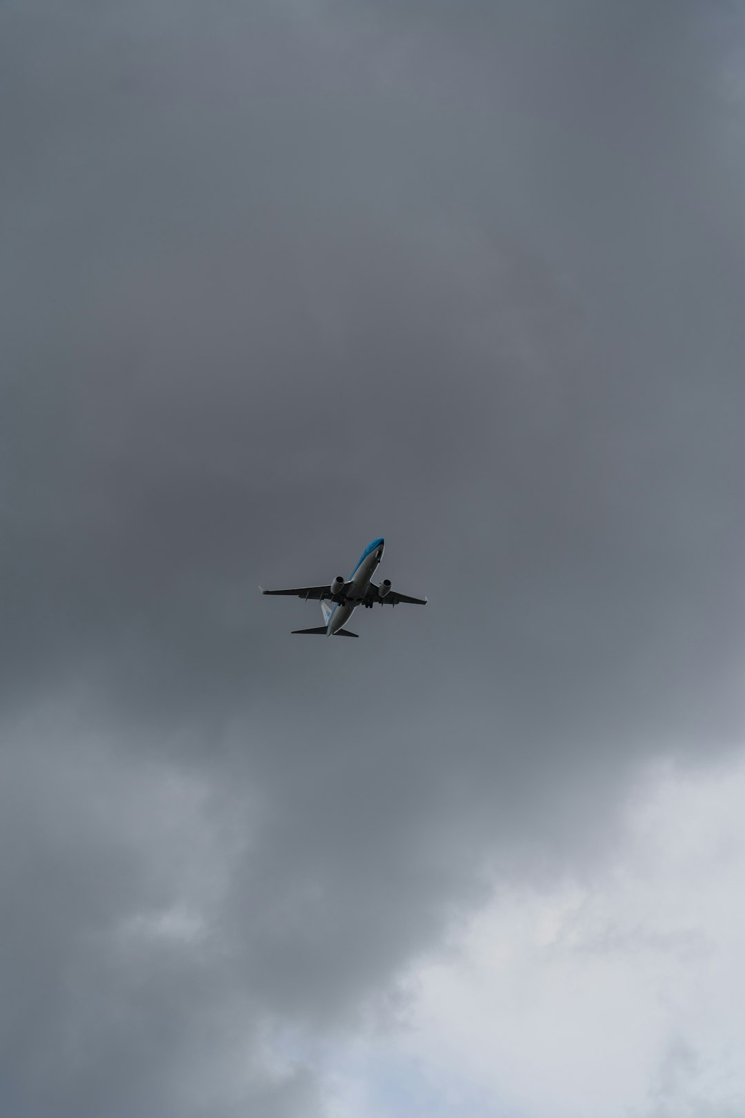 blue and white airplane flying in the sky