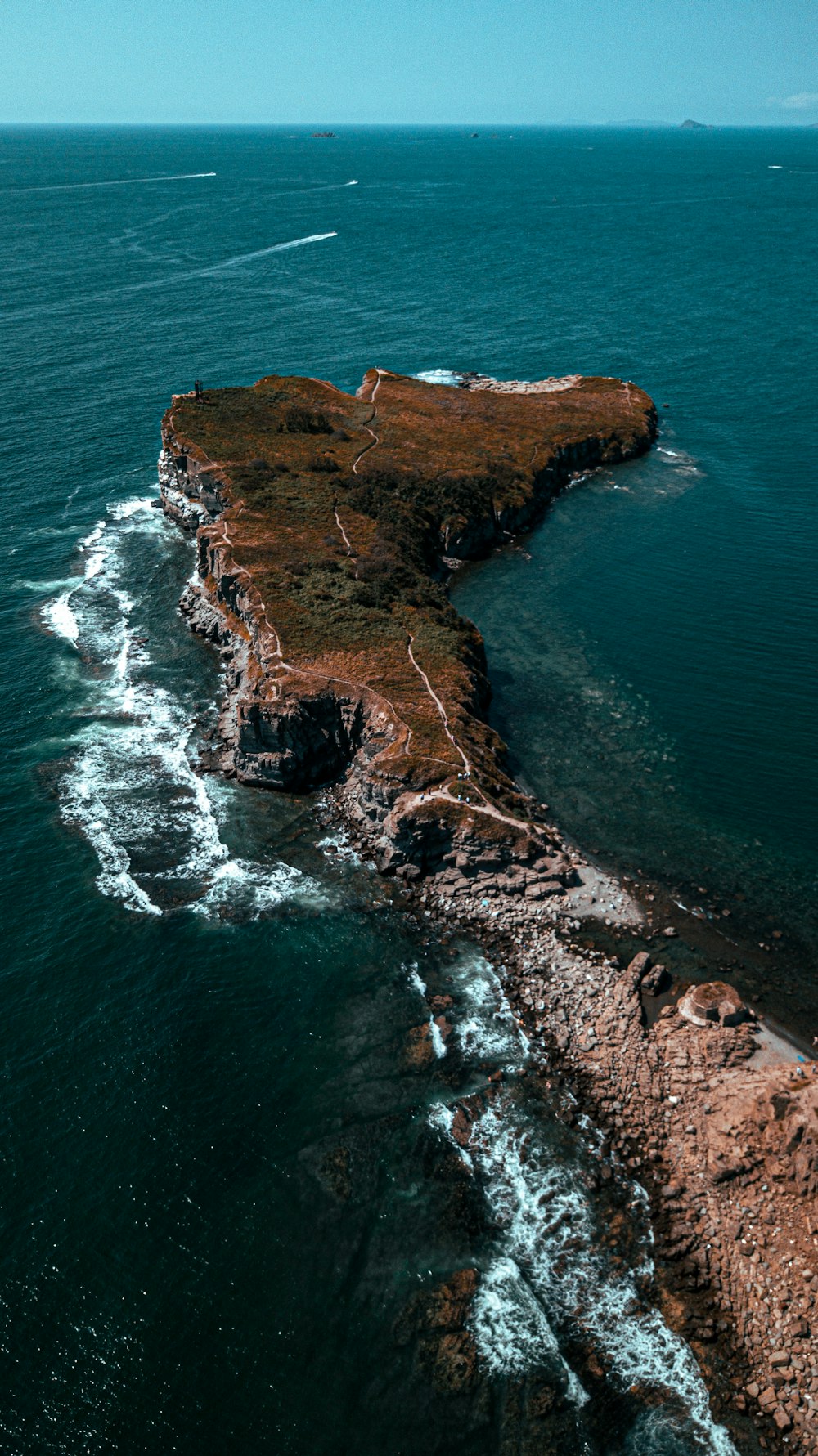 brown rock formation on sea during daytime