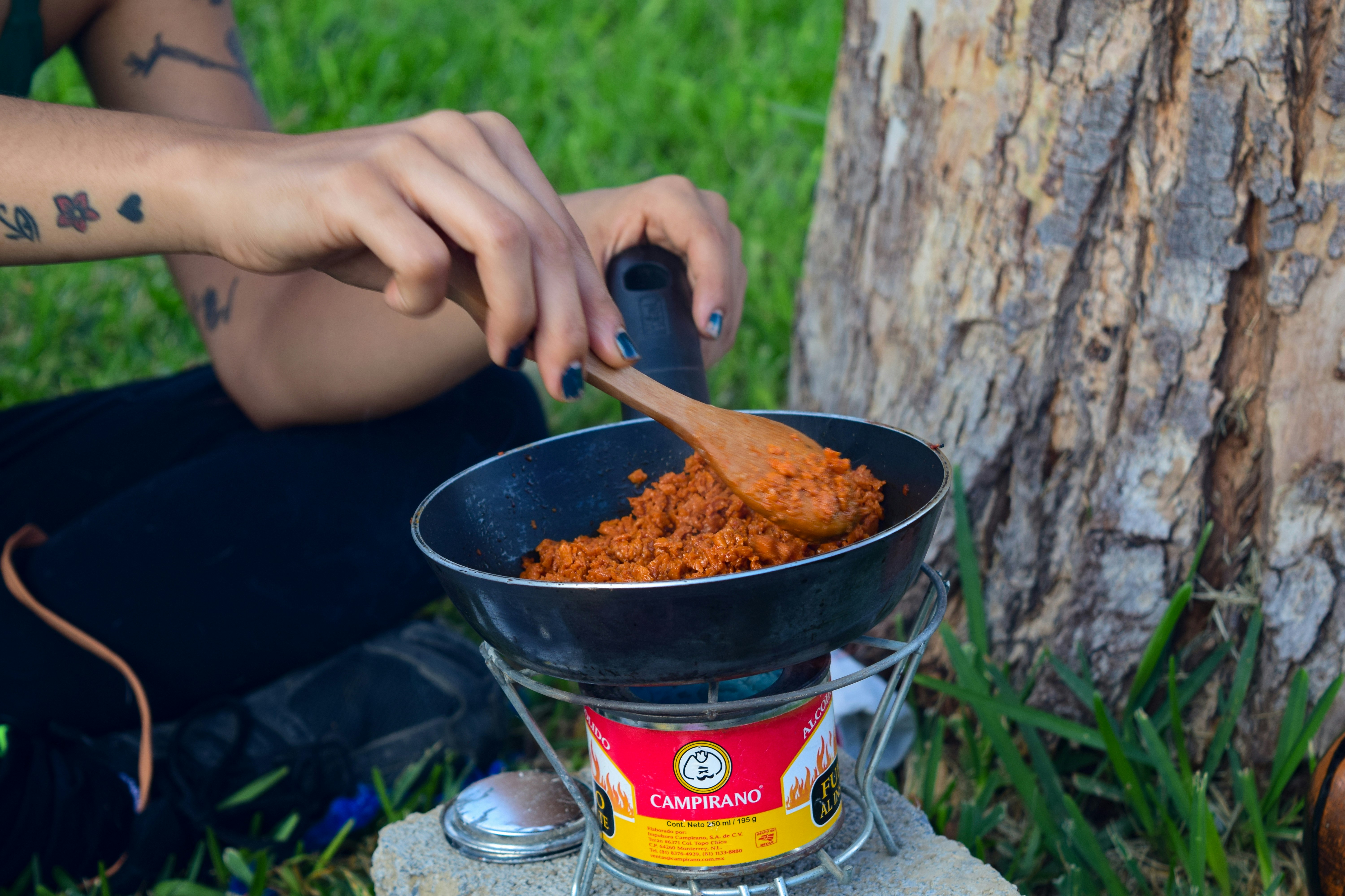 person holding a black and red can
