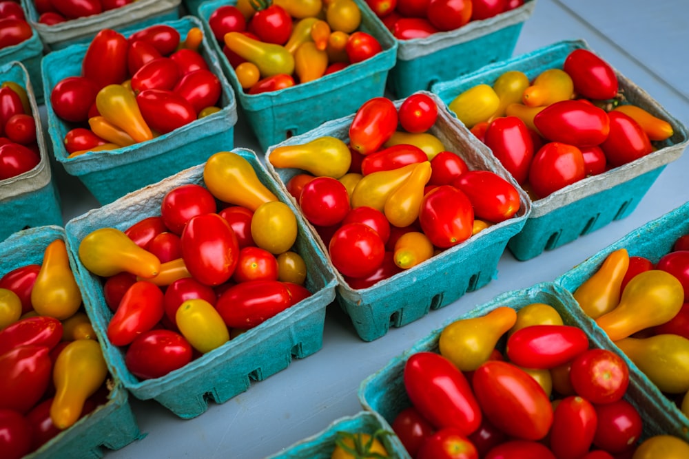 red and yellow bell peppers on blue plastic crate