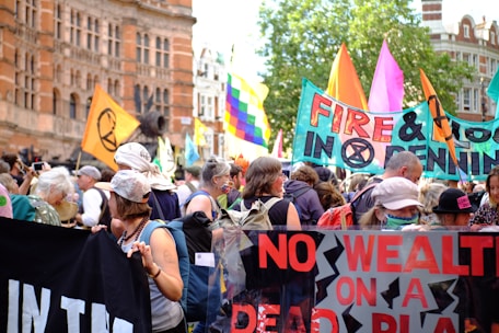 A diverse group of activists holding banners at a climate march in an Arab city.