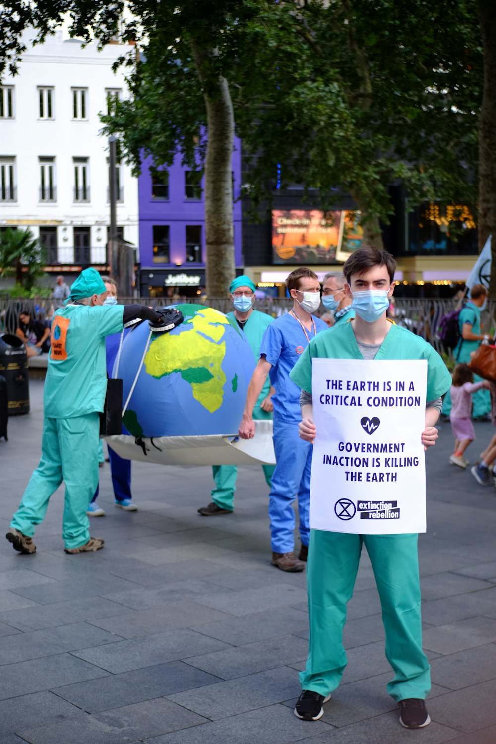 people in green and blue shirts holding white printer paper