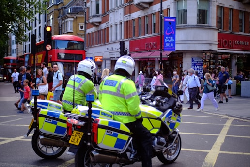 people in green and yellow jacket riding motorcycle during daytime