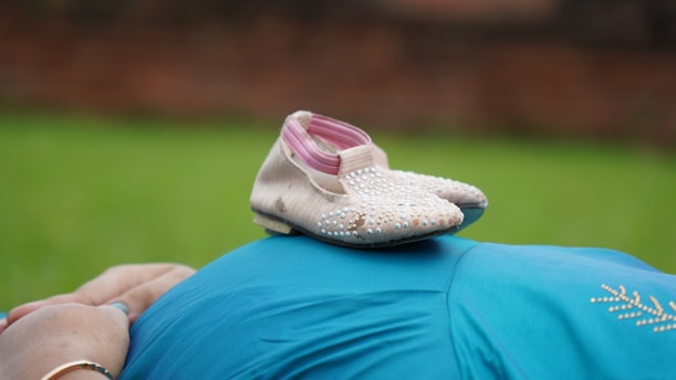white and pink flat shoes on blue textile