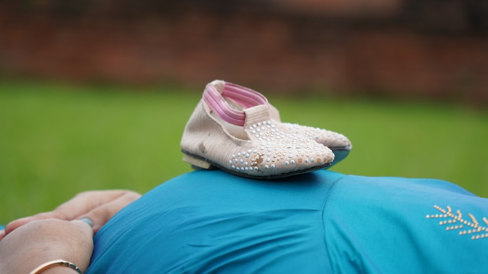 white and pink flat shoes on blue textile