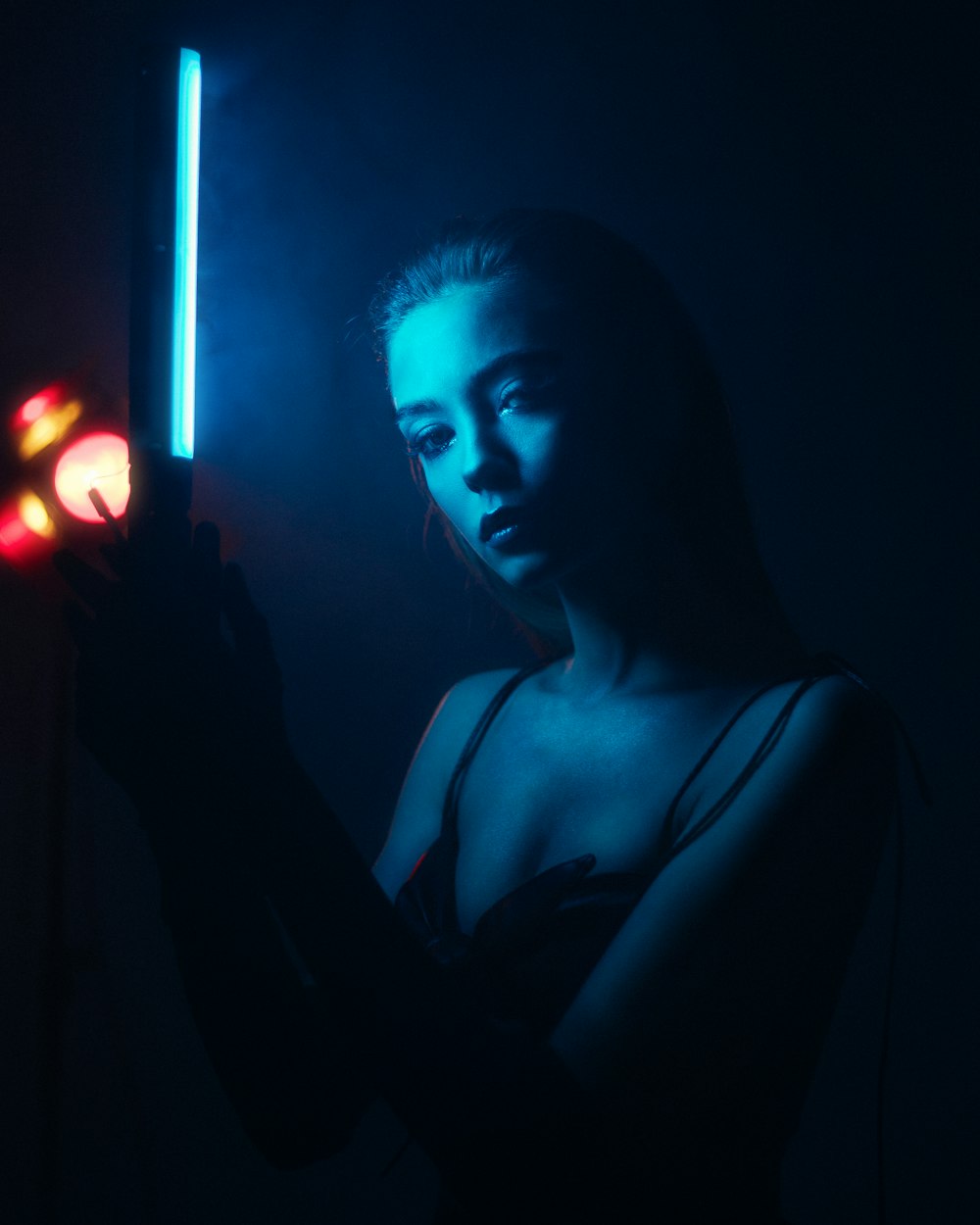 woman in black tank top holding light