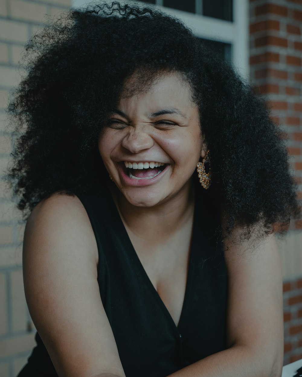 smiling woman in black sleeveless top