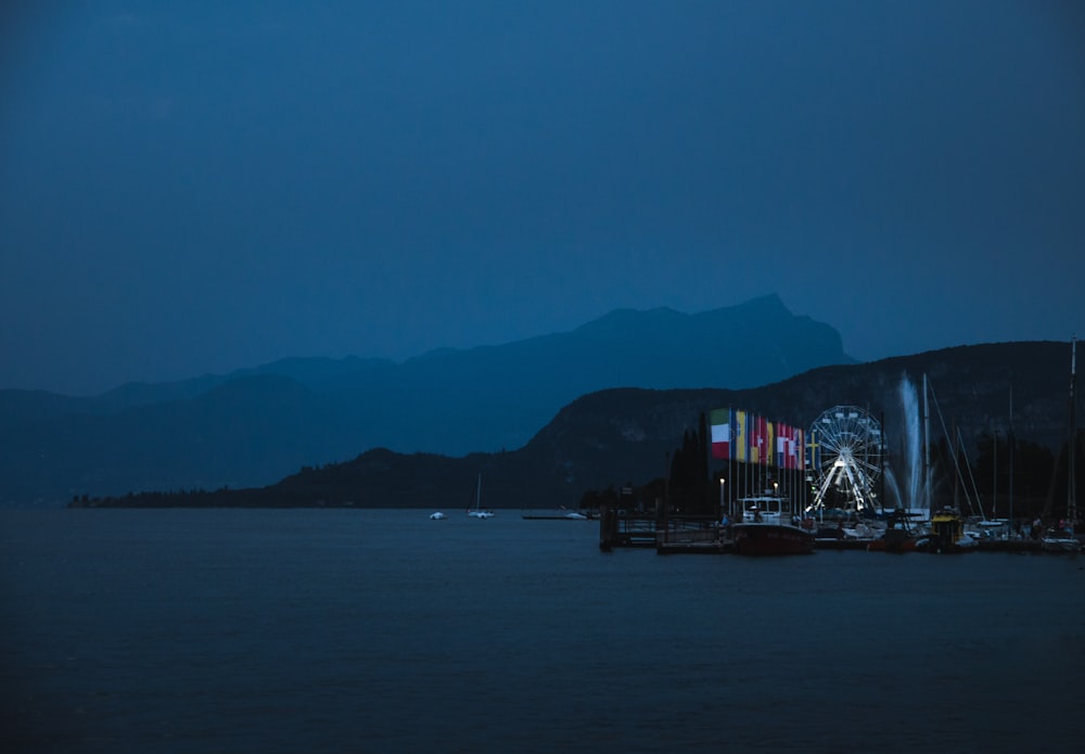 white and red building on body of water during night time