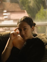 woman in black tank top sitting on couch