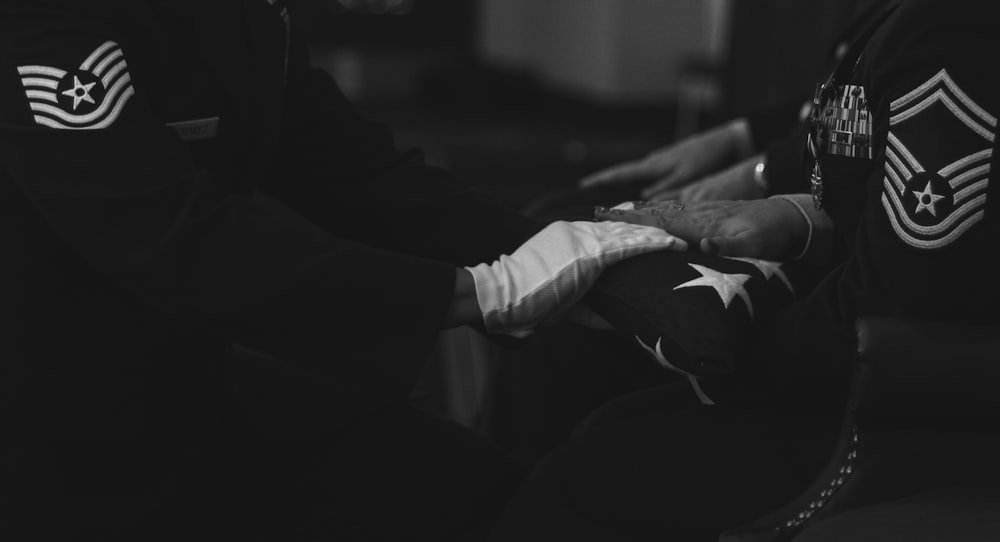 grayscale photo of person holding book