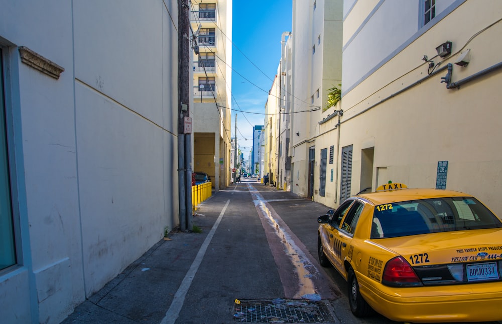 yellow sedan on road during daytime